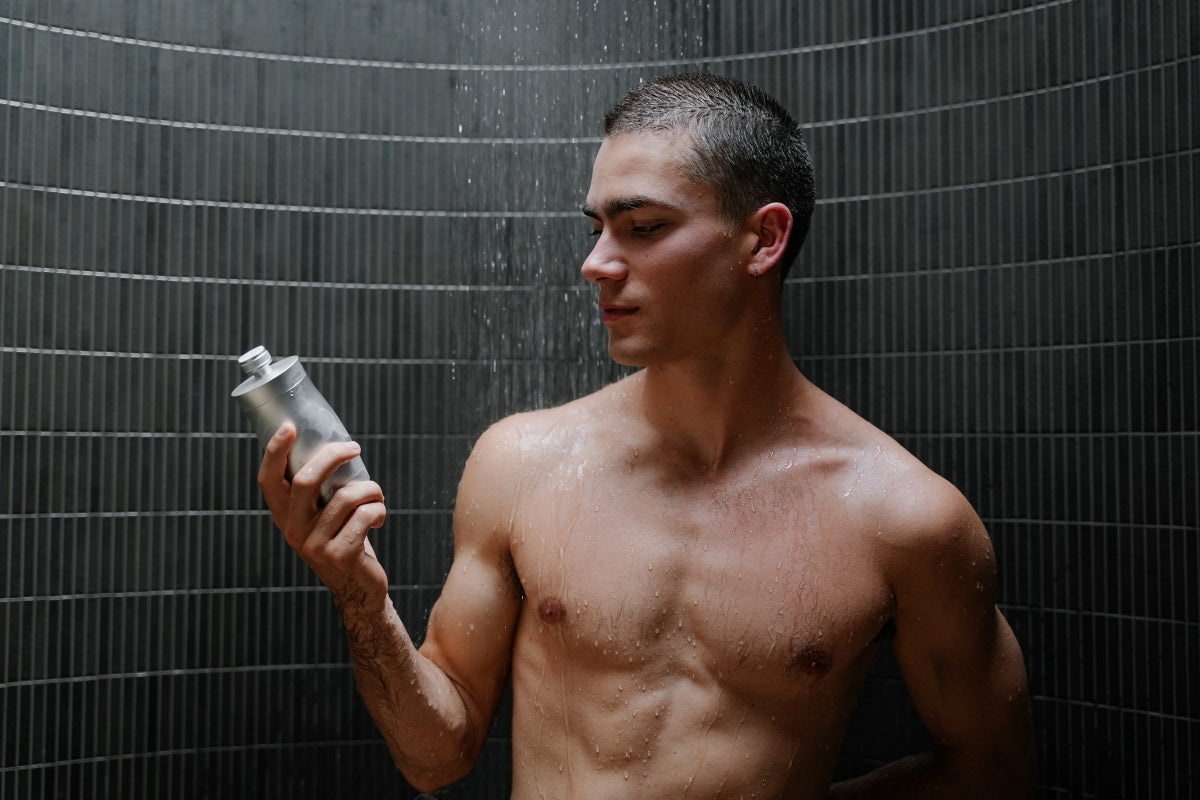 Male holding a shower filter in the shower