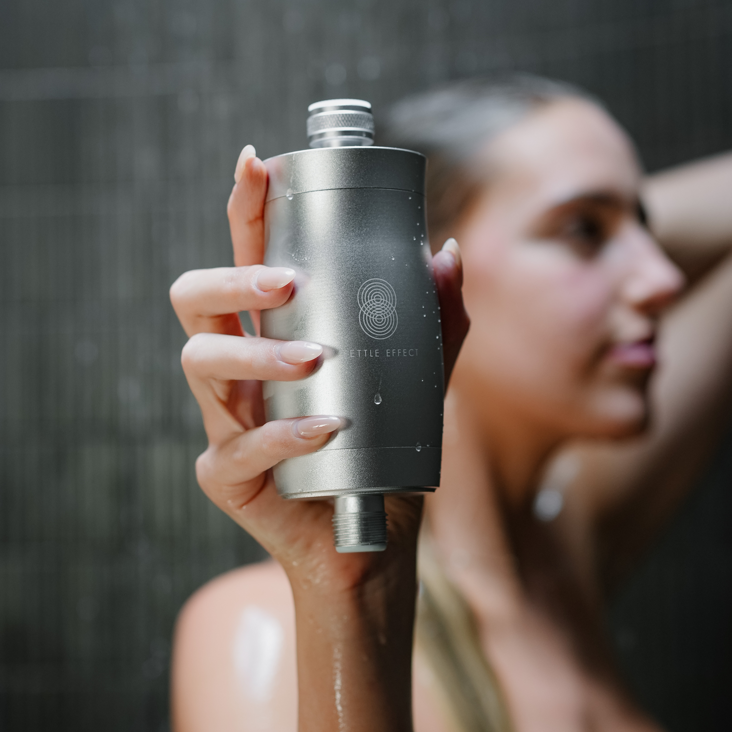 A female holding a shower filter